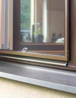 Open window with a dark brown frame and insect screen